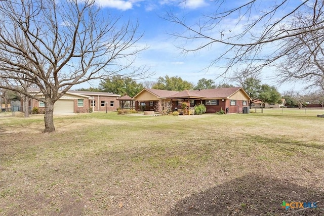 ranch-style home with a front yard and a garage