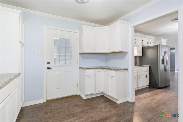 kitchen featuring ornamental molding, stainless steel fridge, white cabinets, baseboards, and dark wood-style flooring