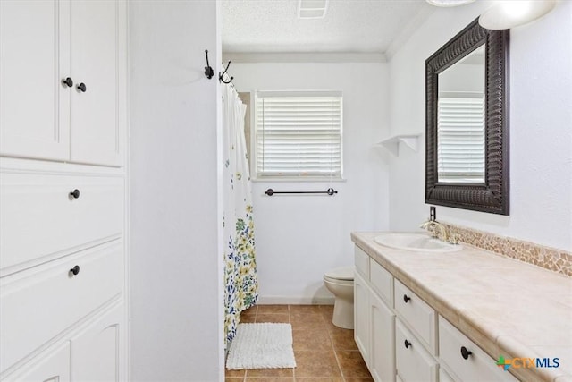 bathroom with tile patterned floors, visible vents, toilet, a textured ceiling, and vanity