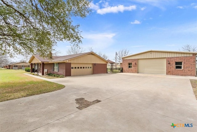 ranch-style home with a garage, brick siding, and a front yard