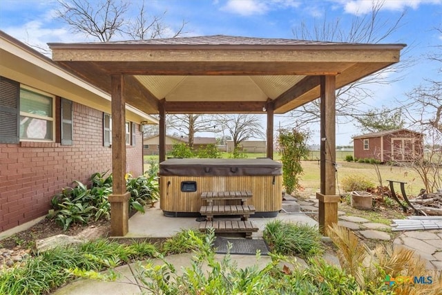 view of patio / terrace featuring a gazebo and a hot tub