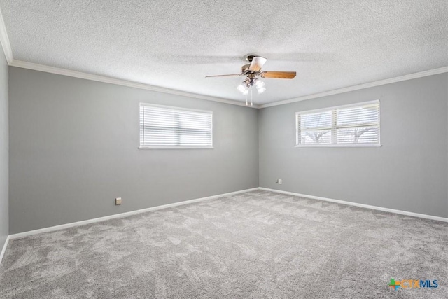 unfurnished room featuring plenty of natural light, crown molding, baseboards, and carpet floors