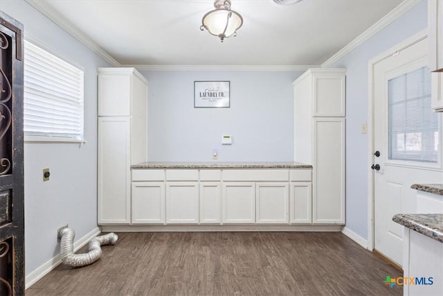 laundry room with cabinet space, hookup for an electric dryer, wood finished floors, and ornamental molding