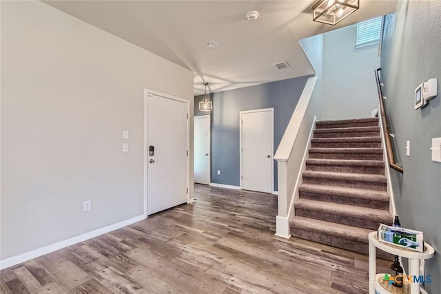 stairs with wood-type flooring