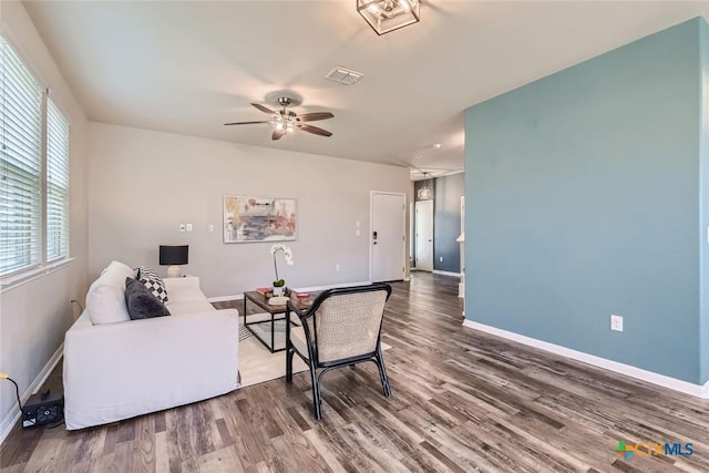 living room with ceiling fan and wood-type flooring