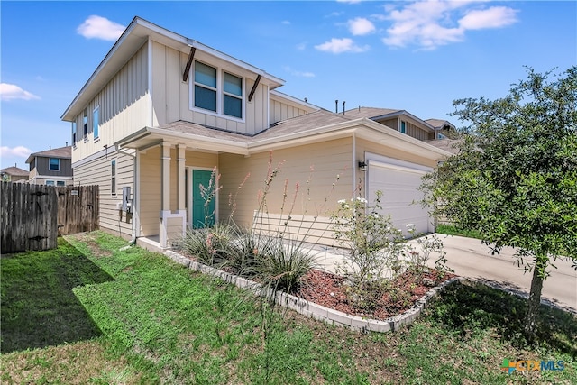 view of front of property with a garage and a front lawn