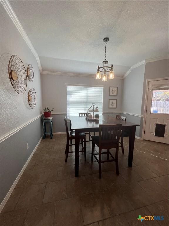 dining area featuring ornamental molding and a notable chandelier