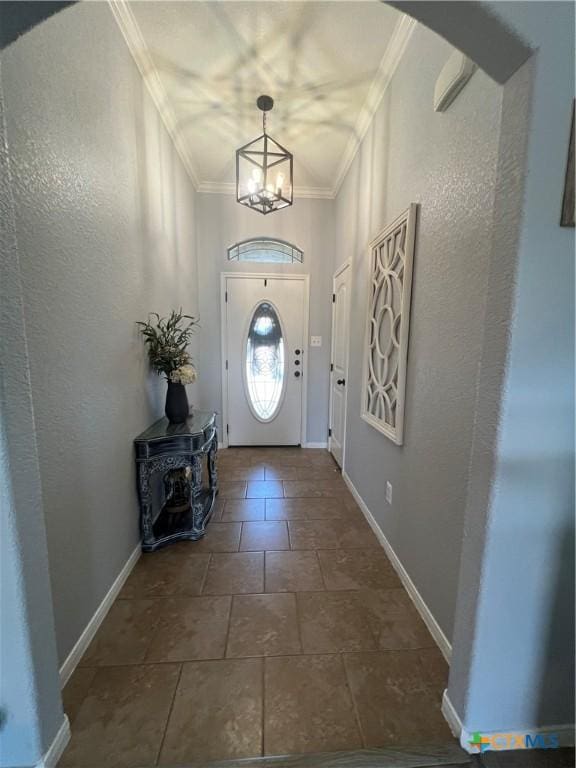 entryway featuring ornamental molding and an inviting chandelier