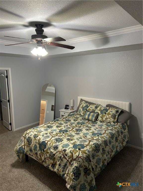 bedroom featuring carpet, ceiling fan, crown molding, and a textured ceiling