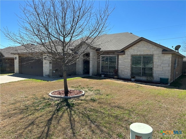 view of front of house featuring a garage, concrete driveway, and a front lawn