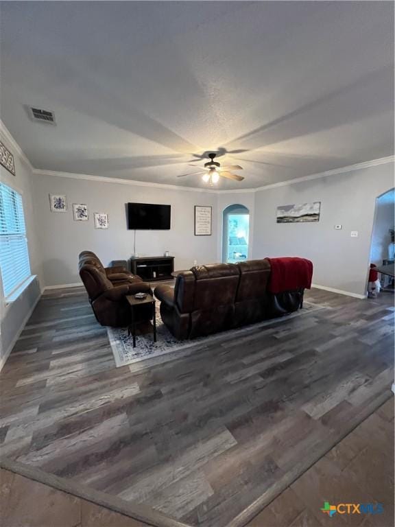 living room with ceiling fan, dark hardwood / wood-style flooring, and crown molding