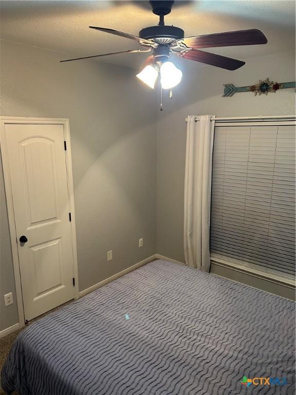 unfurnished bedroom featuring carpet and ceiling fan