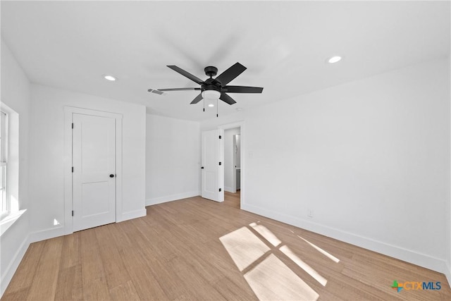 unfurnished bedroom with ceiling fan and light hardwood / wood-style flooring