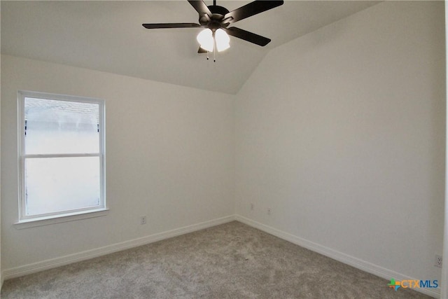 carpeted spare room featuring lofted ceiling, plenty of natural light, and ceiling fan