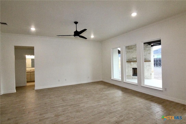 spare room with hardwood / wood-style flooring, crown molding, and ceiling fan