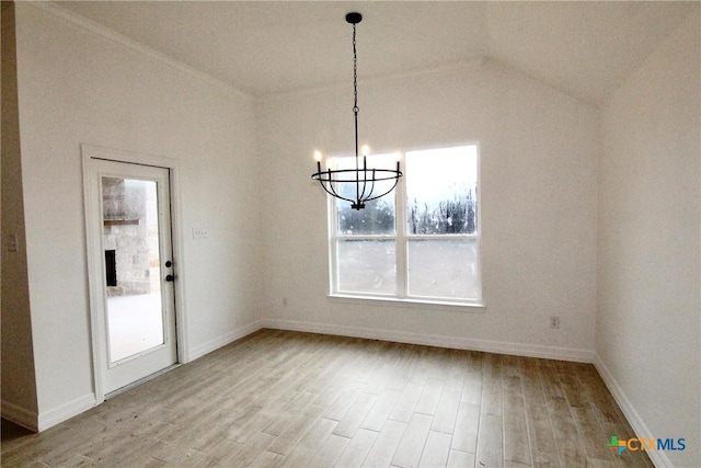 unfurnished dining area featuring lofted ceiling, an inviting chandelier, and light wood-type flooring