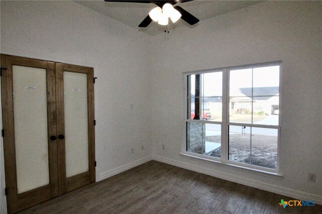 empty room with hardwood / wood-style flooring and ceiling fan