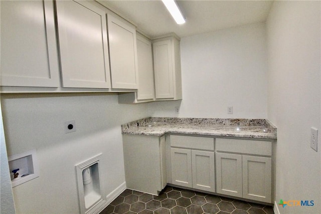 washroom featuring cabinets, electric dryer hookup, and washer hookup