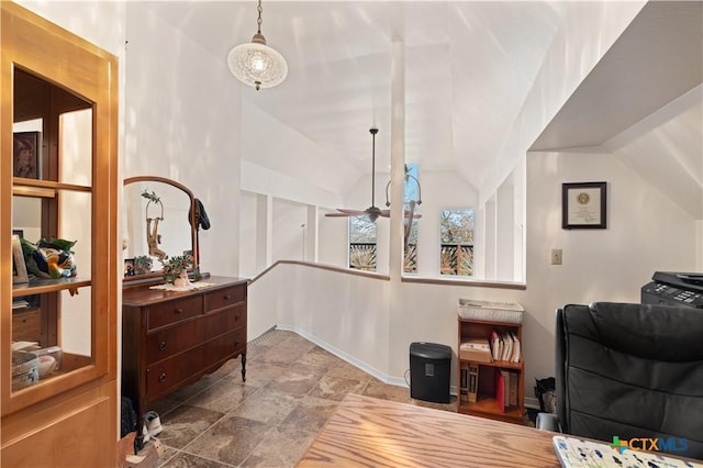 office featuring a ceiling fan, lofted ceiling, and baseboards