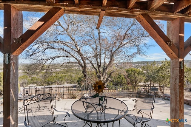 view of patio / terrace featuring fence and outdoor dining area