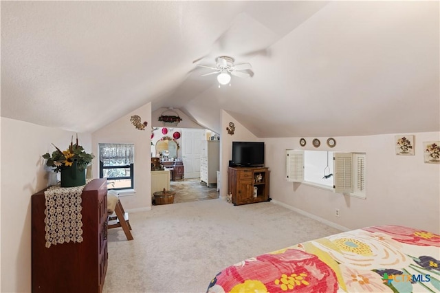 bedroom with carpet floors, baseboards, and vaulted ceiling