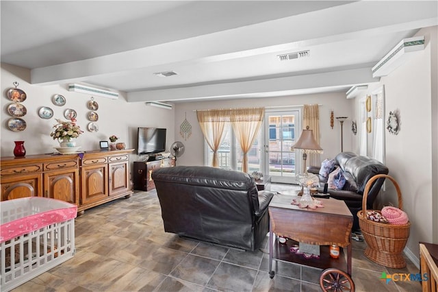 living room with beamed ceiling and visible vents