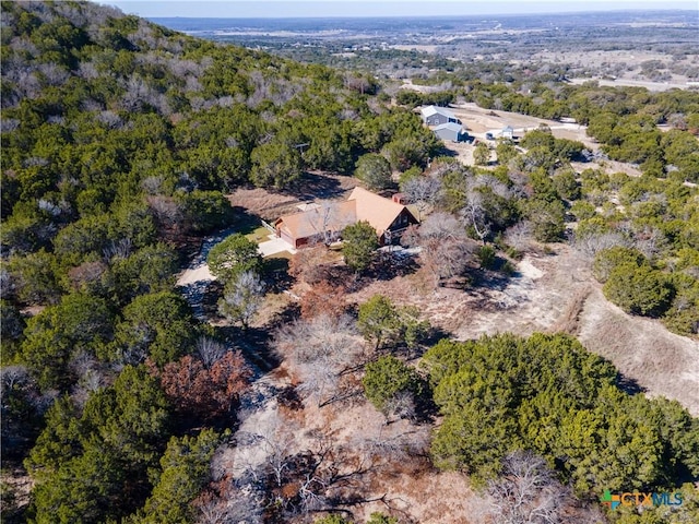 birds eye view of property featuring a view of trees