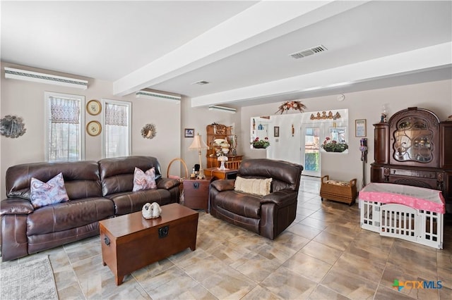 living room with visible vents, an AC wall unit, beamed ceiling, and a wealth of natural light