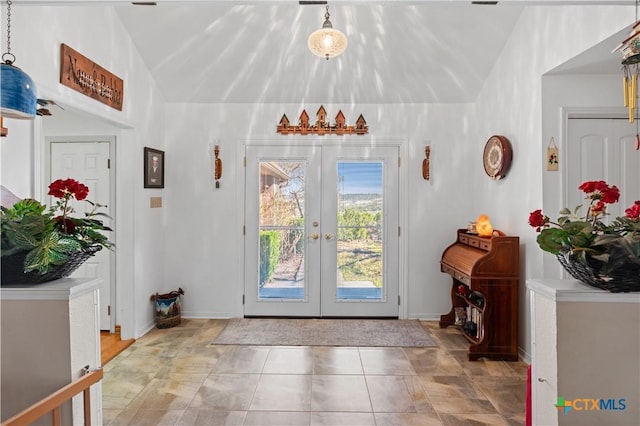 doorway featuring vaulted ceiling, french doors, and baseboards