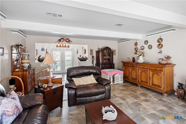 living area with a wall mounted AC, visible vents, beam ceiling, and french doors