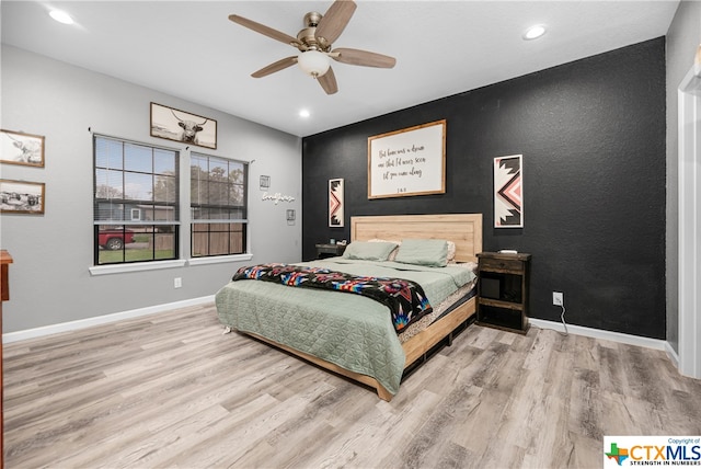 bedroom featuring hardwood / wood-style flooring and ceiling fan