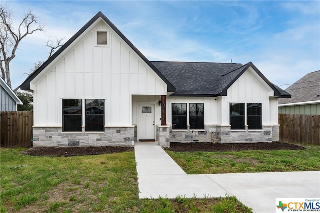 modern farmhouse style home with a front yard