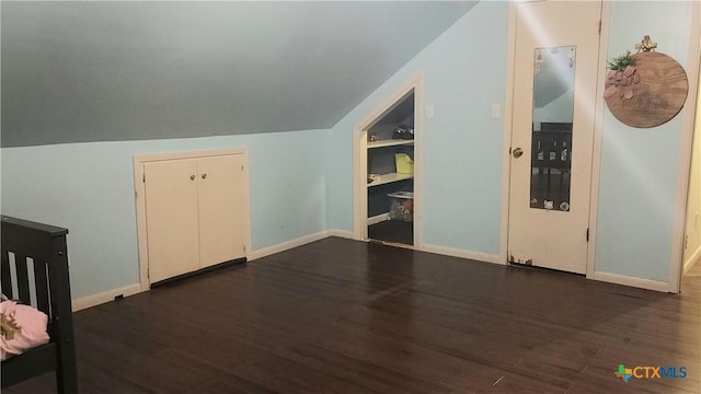 bonus room with dark hardwood / wood-style floors and lofted ceiling