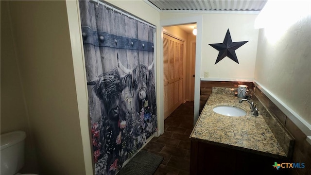 bathroom featuring vanity and toilet