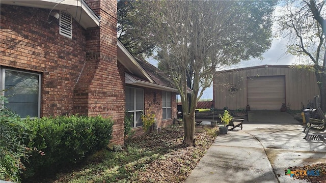 view of side of home featuring an outbuilding and a garage