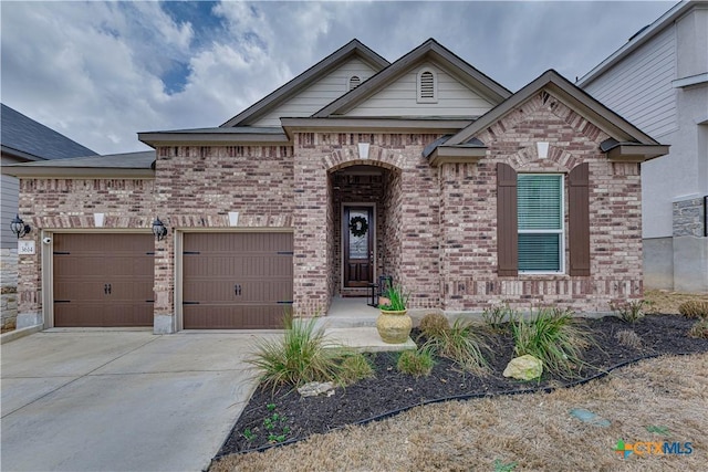 view of front of home featuring driveway, brick siding, and an attached garage