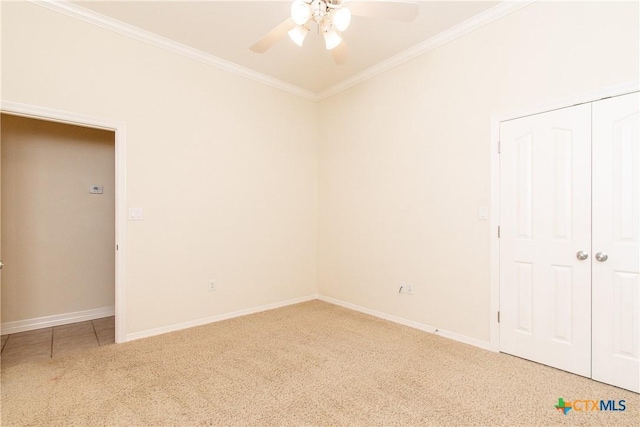 unfurnished room featuring carpet floors, ornamental molding, and ceiling fan