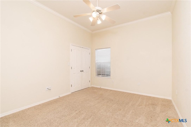 carpeted empty room with ornamental molding and ceiling fan