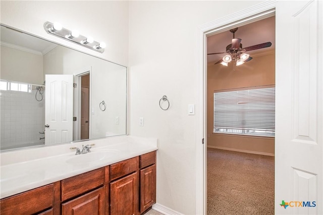 bathroom featuring ceiling fan, ornamental molding, bathing tub / shower combination, and vanity