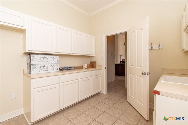 kitchen with white cabinetry, sink, crown molding, and light tile patterned flooring