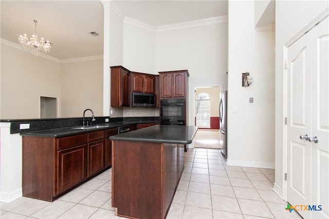 kitchen featuring sink, crown molding, a center island, light tile patterned floors, and stainless steel appliances