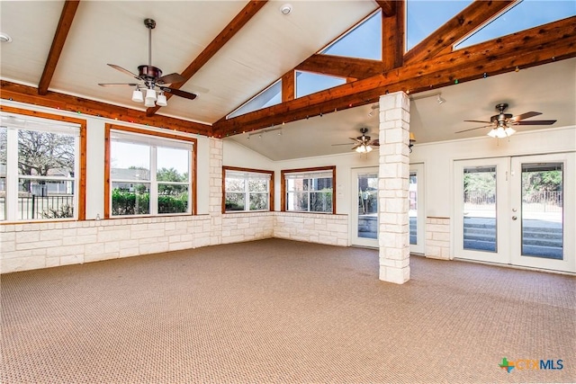 unfurnished sunroom with a wealth of natural light, decorative columns, and ceiling fan