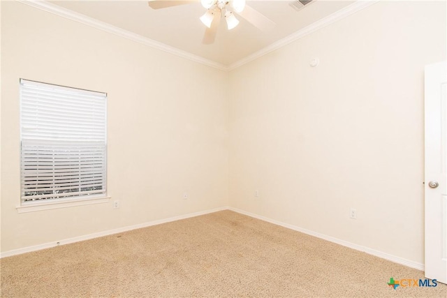 empty room featuring carpet floors, ornamental molding, and ceiling fan