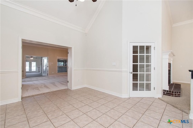 empty room with light carpet, high vaulted ceiling, ornamental molding, and ceiling fan