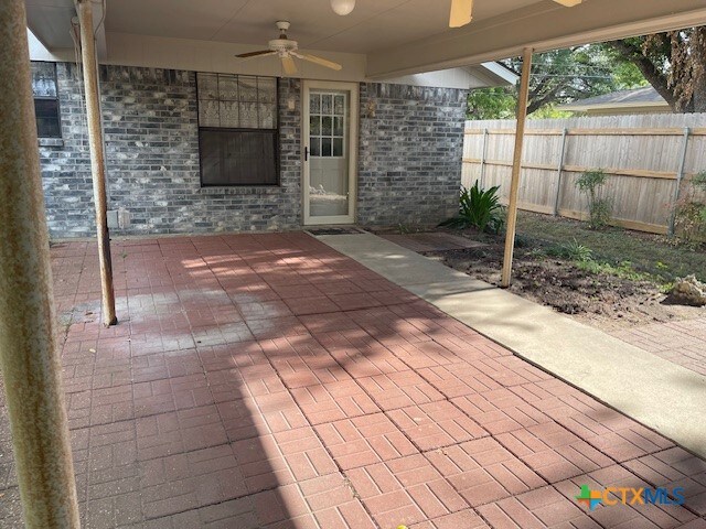 view of patio featuring ceiling fan