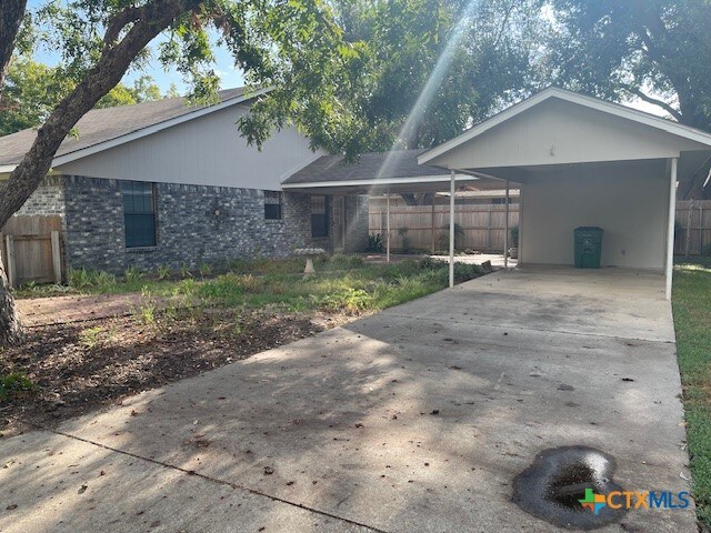 rear view of property with a carport