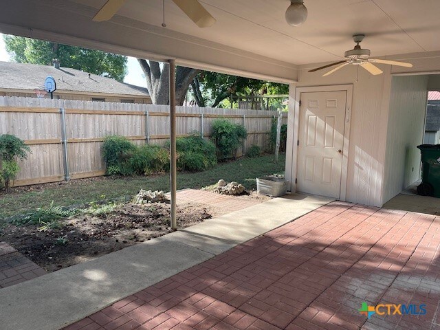 view of patio / terrace with a storage shed and ceiling fan