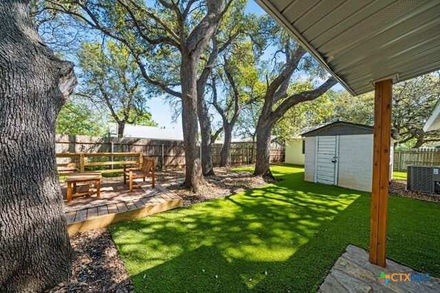 512 W Pecan Dr, Johnson City, TX 78636 - view of yard featuring central AC and a patio area