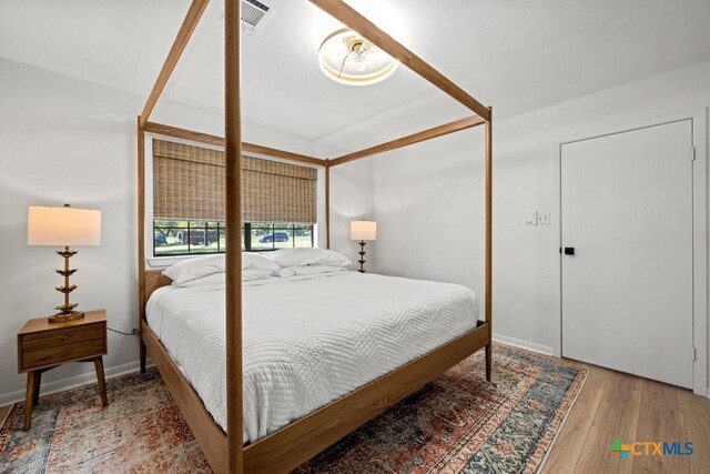 512 W Pecan Dr, Johnson City, TX 78636 - bedroom featuring wood finished floors