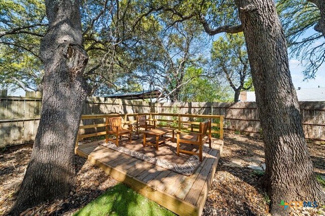 512 W Pecan Dr, Johnson City, TX 78636 - wooden terrace featuring a fenced backyard